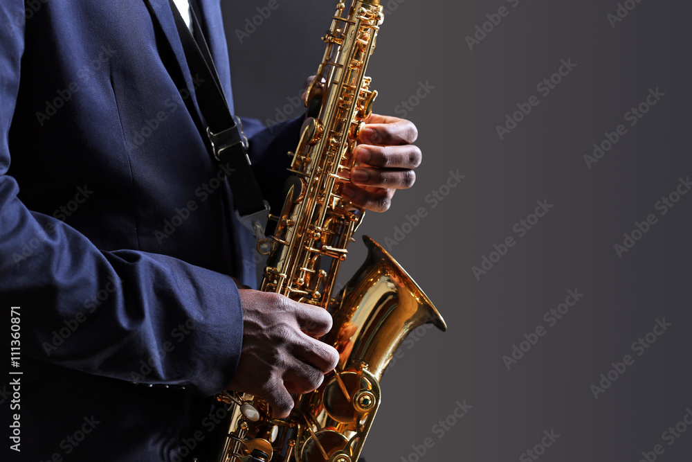 Fototapeta premium African American jazz musician playing the saxophone, closeup