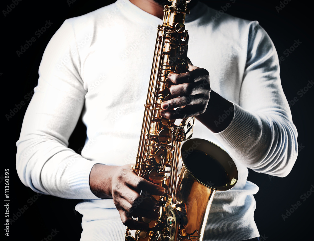 Fototapeta premium African American jazz musician playing the saxophone, closeup