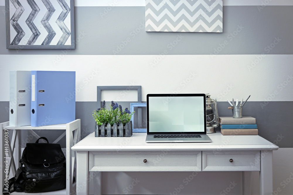 Stylish workplace with laptop at home Stylish workplace with laptop at home