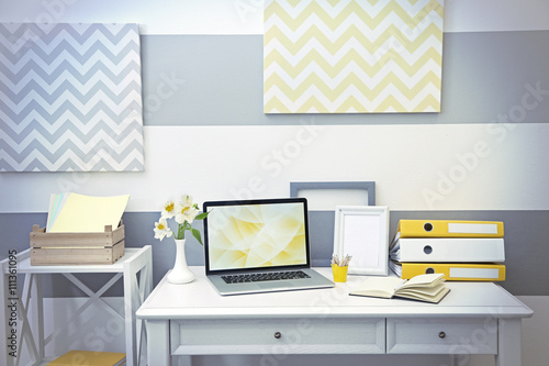 Stylish workplace with lapt...