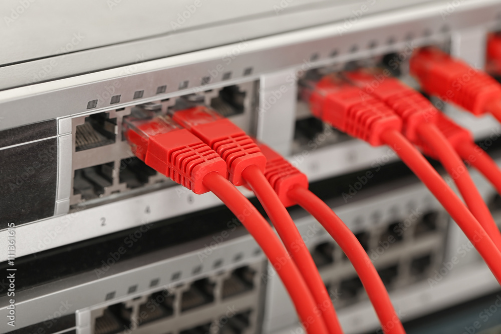 Red Ethernet cables connected to network switch, close up Red Ethernet cables connected to network switch, close up