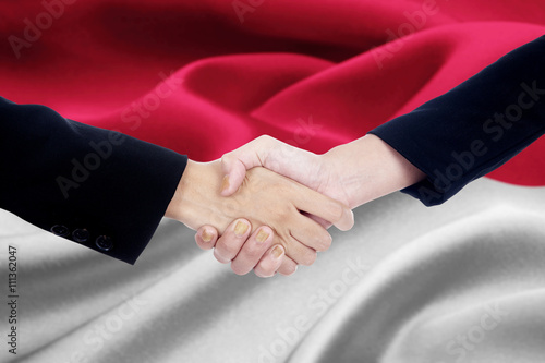 Negotiation handshake with flag of Monaco