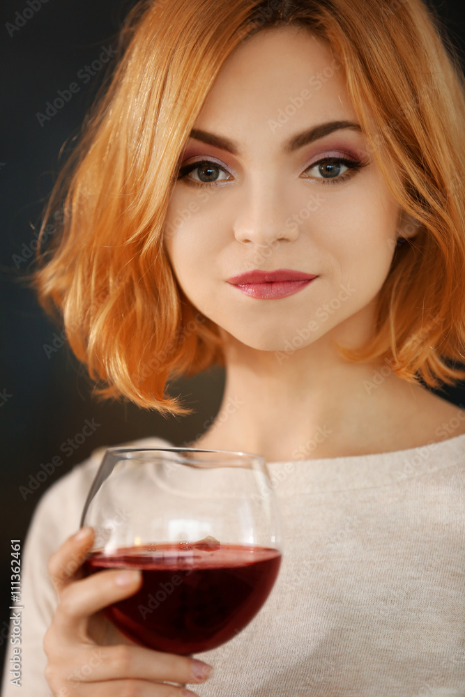 Young woman with glass of red wine closeup Young woman with glass of red wine closeup