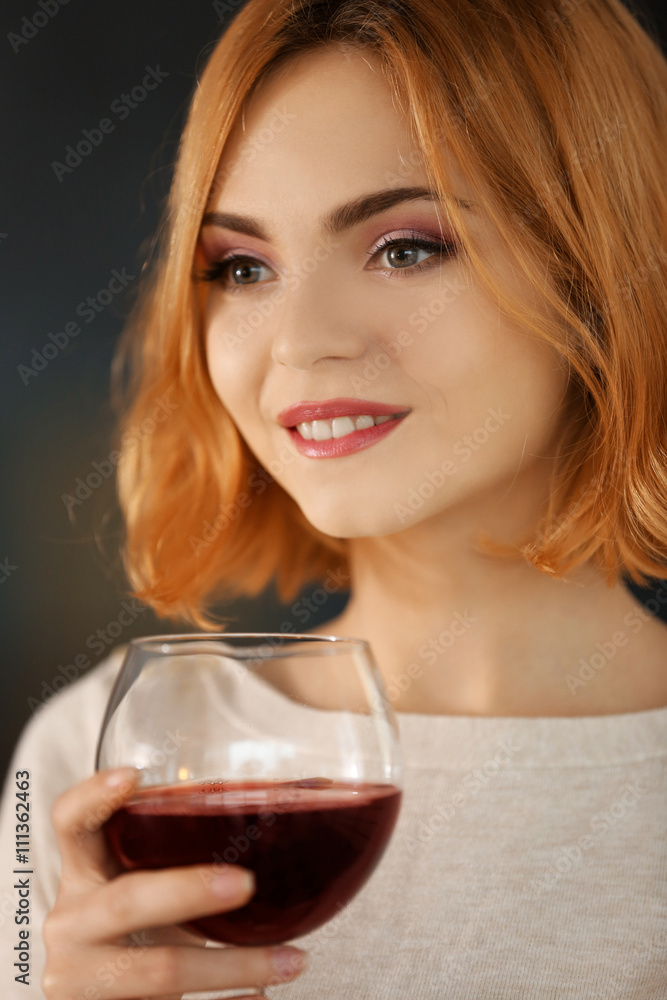 Young woman with glass of red wine closeup Young woman with glass of red wine closeup