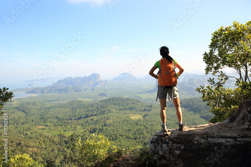 successful woman hiker enjoy the view on mountain top © lzf
