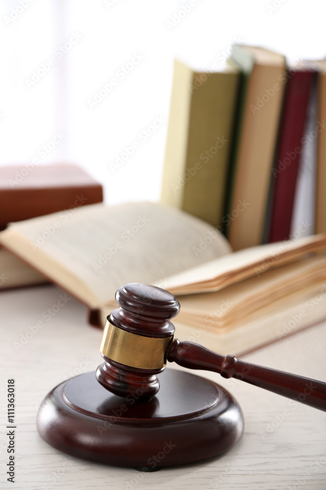 Gavel with books on wooden table closeup Gavel with books on wooden table closeup