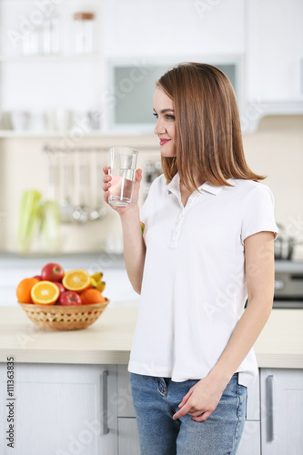 Young woman drinking water ...