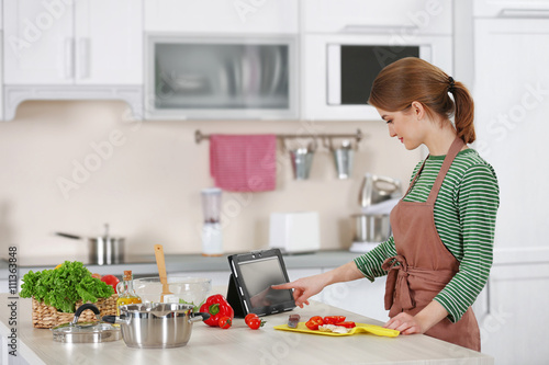 Young woman cooking in the ...