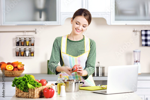 Young woman cooking in the ...