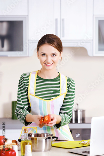 Young woman cooking in the ...