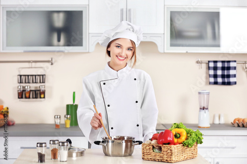 Young woman cooking in the ...