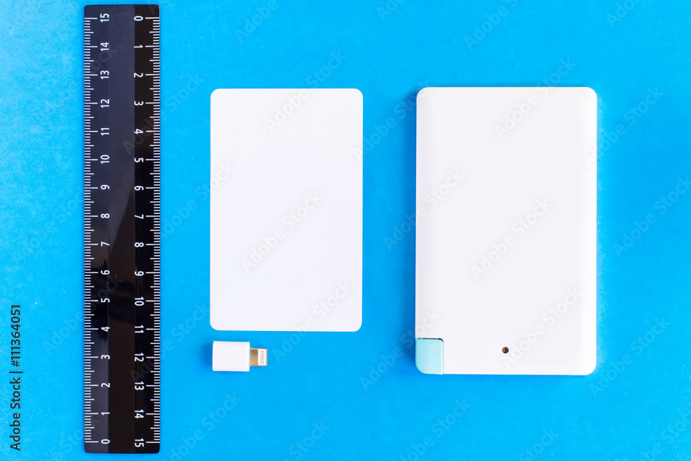 power bank small mini size at credit card and rulers on black ba Stock ...