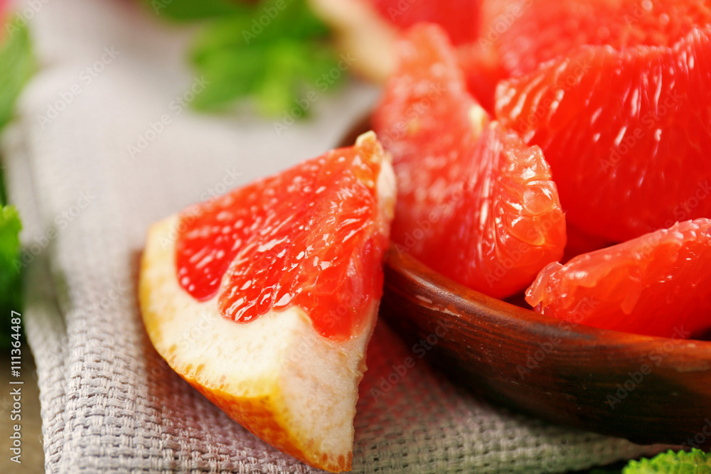 Juicy grapefruit pieces with fresh mint in a bowl, close up Juicy grapefruit pieces with fresh mint in a bowl, close up