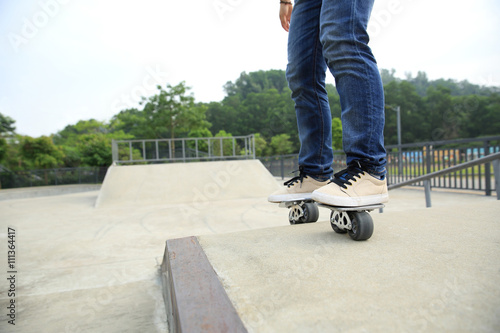 freeline skateboarder legs riding on freeline at skatepark