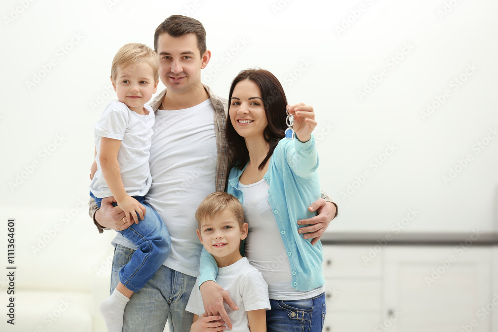 Happy family with key in new house, indoor