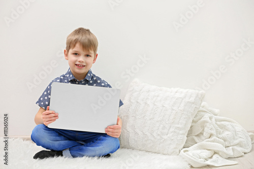 Little boy with laptop on w...