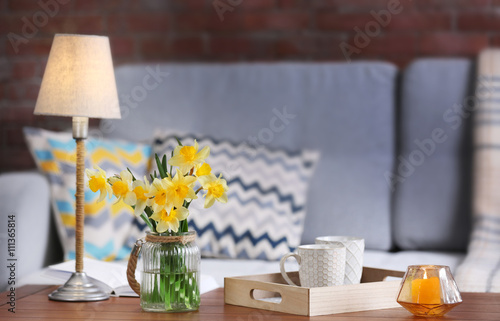 Yellow narcissus in living room interior