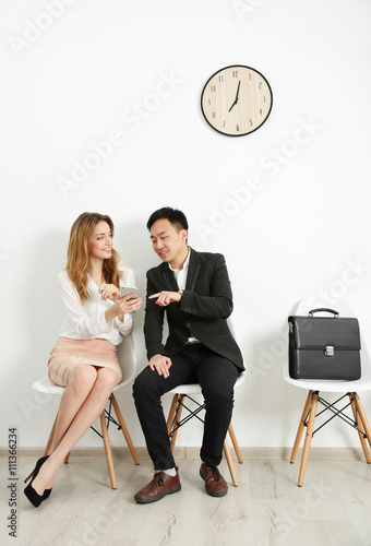 Man and woman waiting for i...