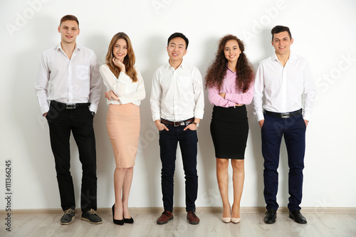 Portrait of young people against white wall background photo