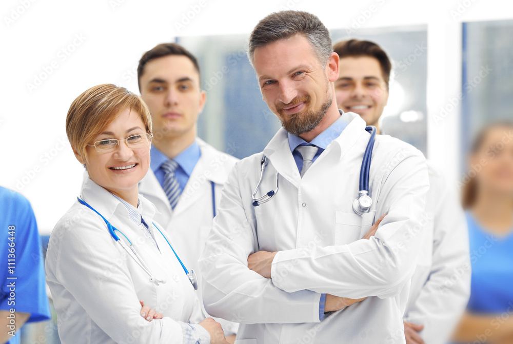 A group of doctors and nurses standing in the hospital, indoors A group of doctors and nurses standing in the hospital, indoors