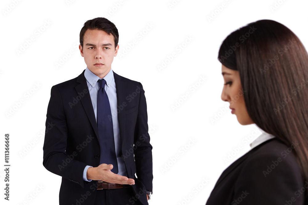 Young Caucasian business man reprimanding business woman