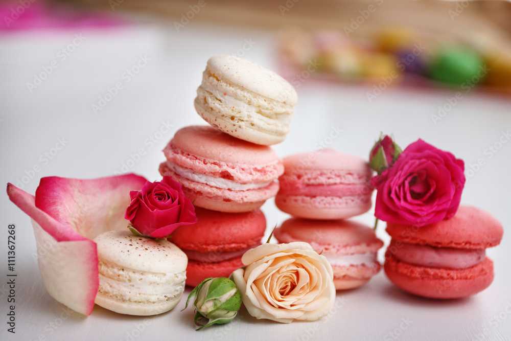 Macaroons with roses on white background Macaroons with roses on white background