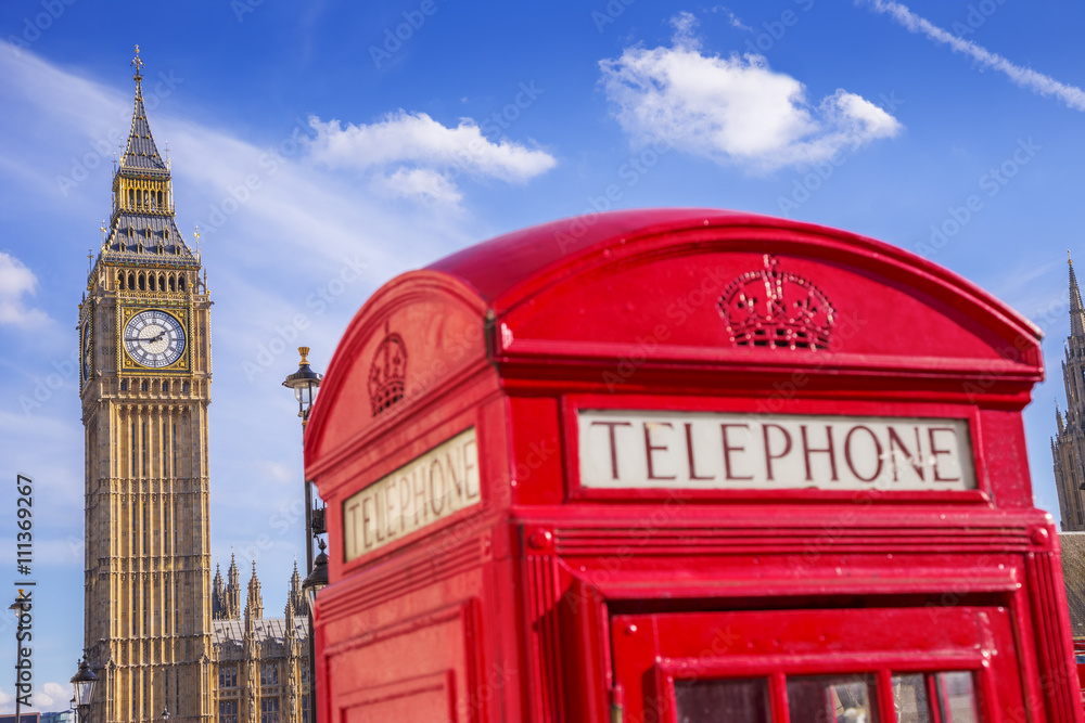 The Big Ben with famous British red telephone box on a sunny day with blue sky - London, UK