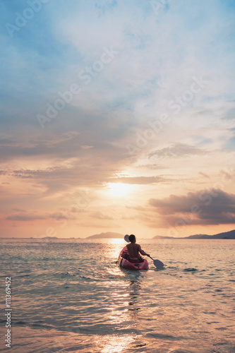 a guy on kayak boating to sunset, vintage tone, abstract concept  © SasinParaksa