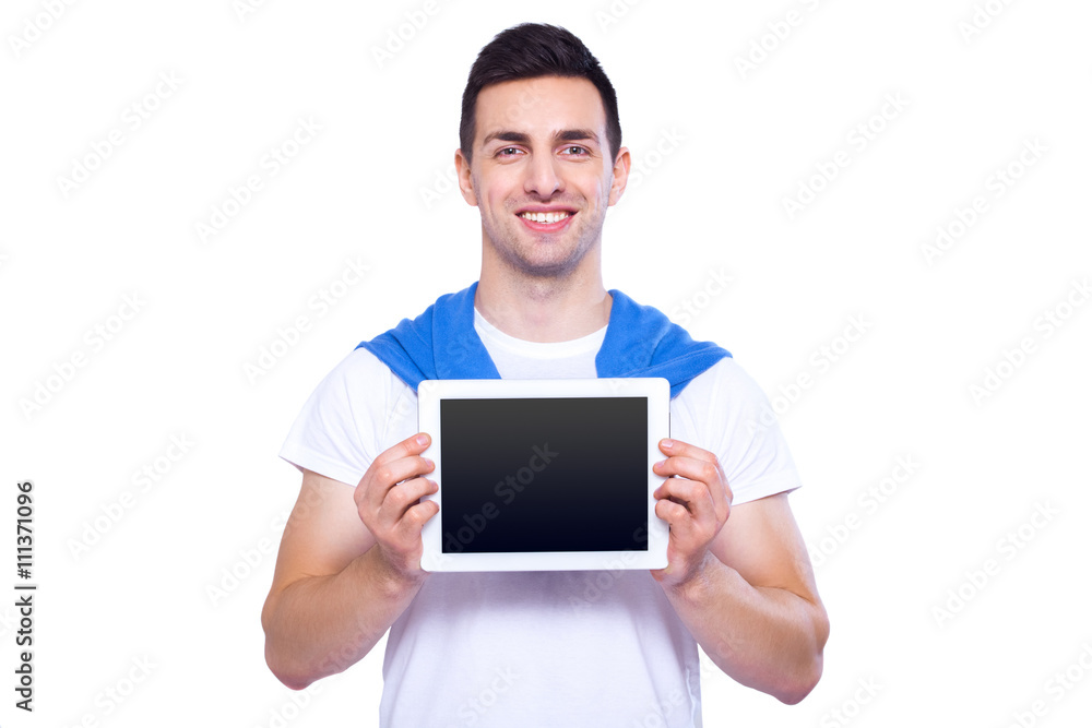 Copy space on his tablet. Happy young man showing his digital tablet and smile while standing isolated on white background Copy space on his tablet. Happy young man showing his digital tablet and smile while standing isolated on white background