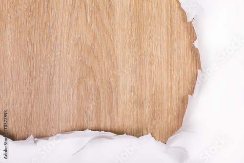 Torn paper wooden surface closeup photo