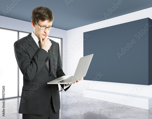 Thoughtful man with laptop photo