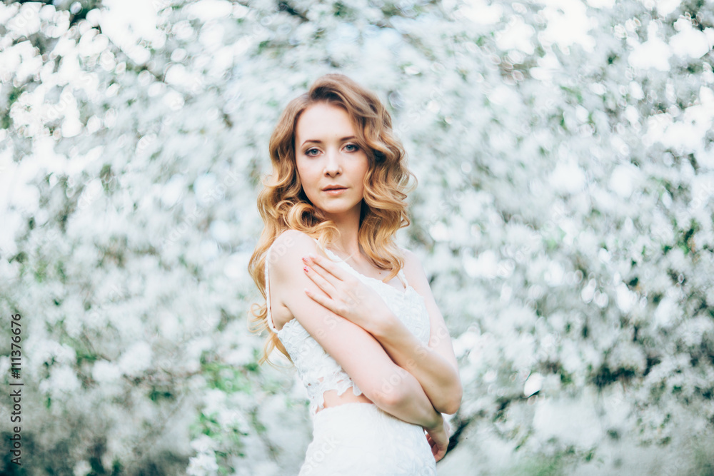 Spring beautiful girl, blonde, standing in a blooming Apple orchard . Spring beautiful girl, blonde, standing in a blooming Apple orchard .