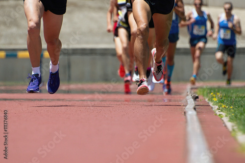 Athletics people running on the track field © pavel1964