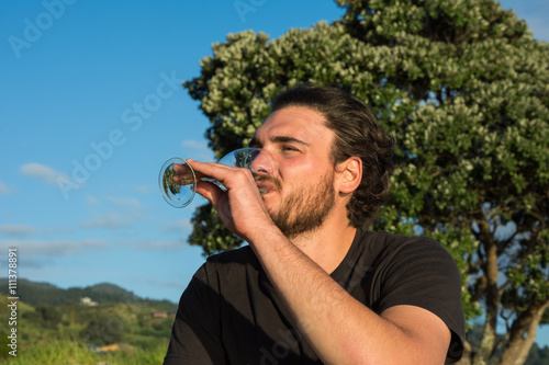 Men enjoying a glass of white wine in the nature