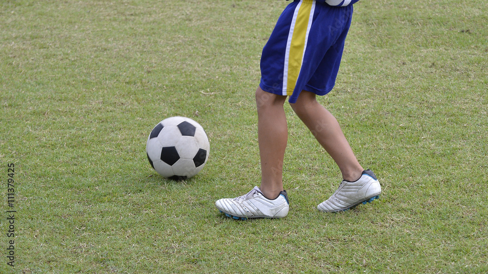 Soccer shoes & football on the green grass Soccer shoes & football on the green grass