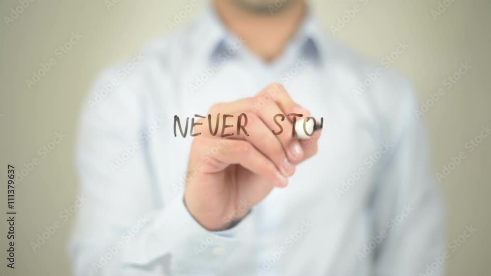 Never Stop Dreaming, Man writing on transparent screen Never Stop Dreaming, Man writing on transparent screen