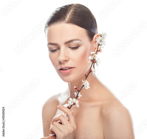 beautiful young woman holding sakura branch