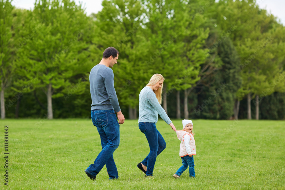 Happy young family  together outside in green nature.