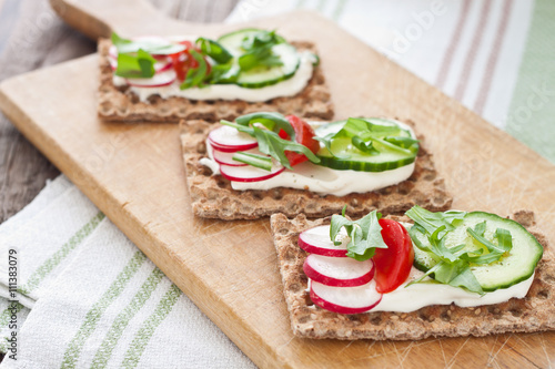 Fotografía Crispbread with tomatoes, radish, cucumber and arugula