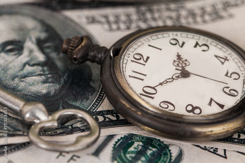 Time and money concept image - old silver pocket watch and US cu Time and money concept image - old silver pocket watch and US cu
