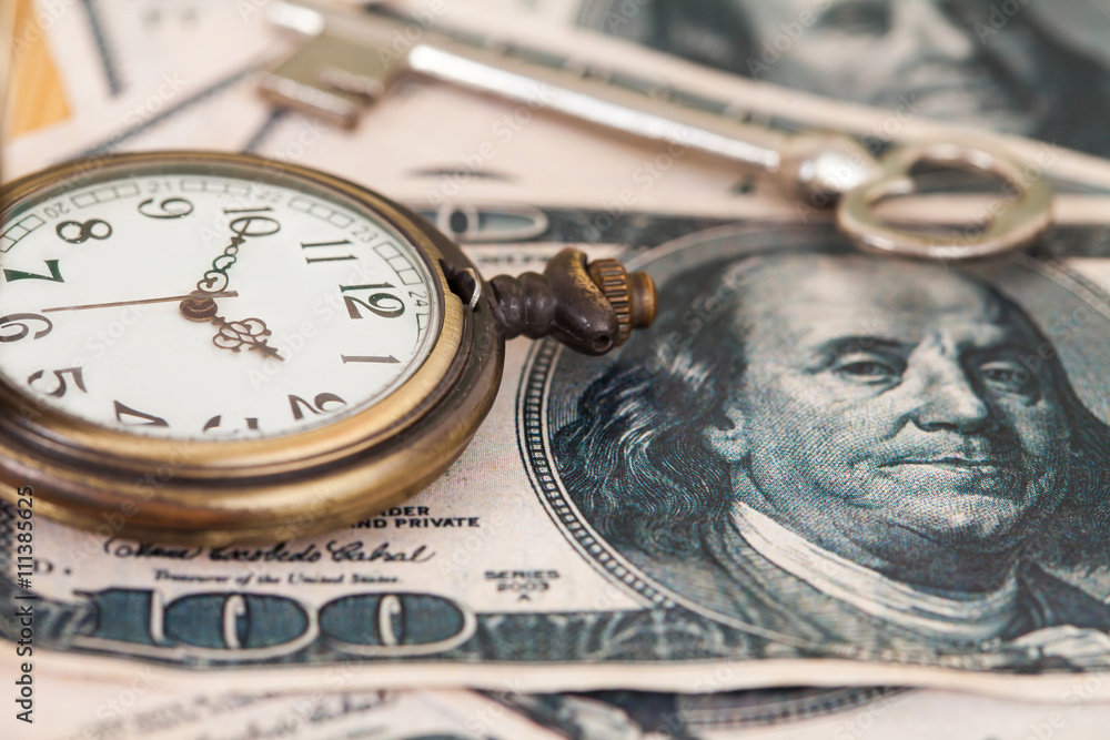 Time and money concept image - old silver pocket watch and US cu Time and money concept image - old silver pocket watch and US cu