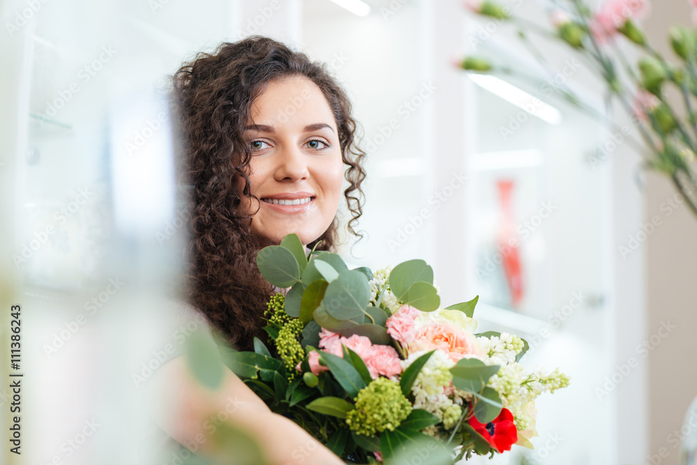 Smiling young woman with beautiful bouquet of flowers Smiling young woman with beautiful bouquet of flowers
