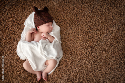 Serene newborn baby sleeping wrapped in diaper
