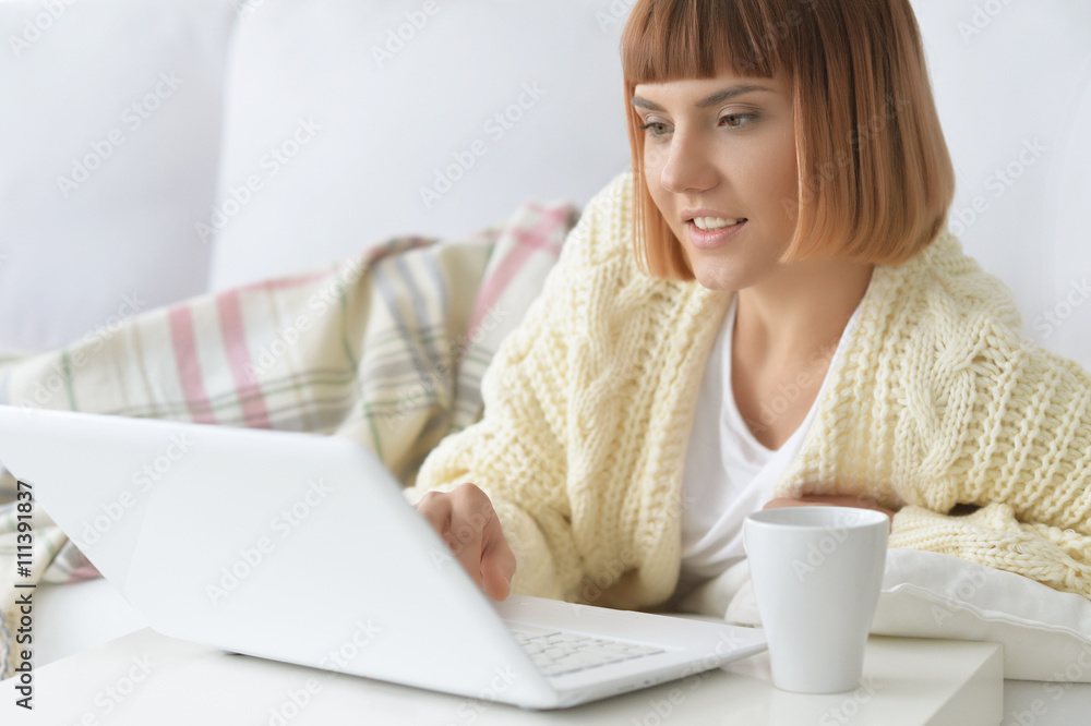 Woman using laptop computer at home Woman using laptop computer at home