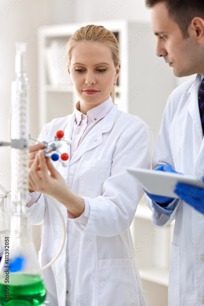 group of scientist analyzing molecular structure. group of scientist analyzing molecular structure.