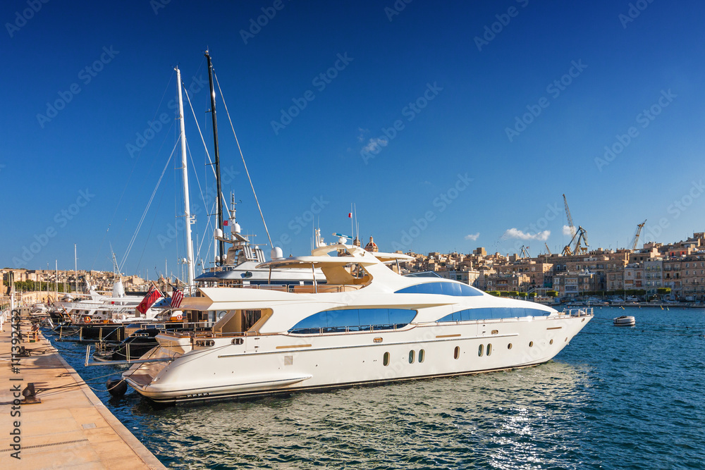 Beautiful yacht on the pier in Valletta port, Malta.
