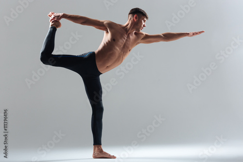Handsome man doing balance pose