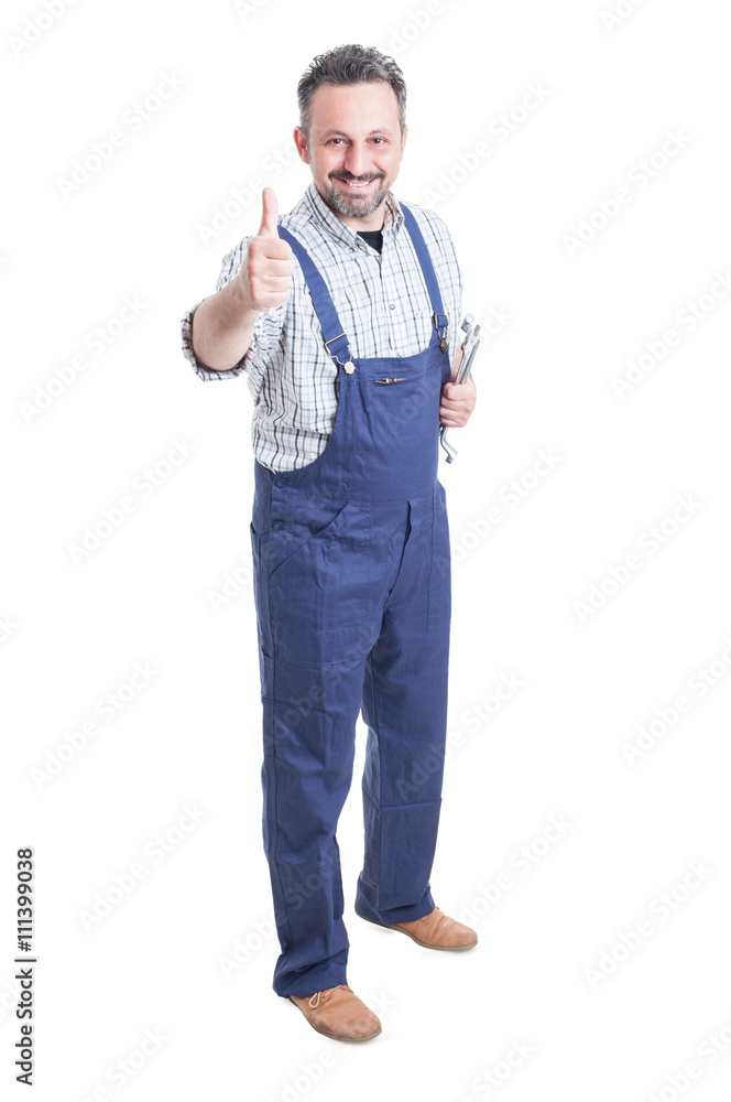 Full body of cheerful mechanic with spanner showing thumbup Full body of cheerful mechanic with spanner showing thumbup