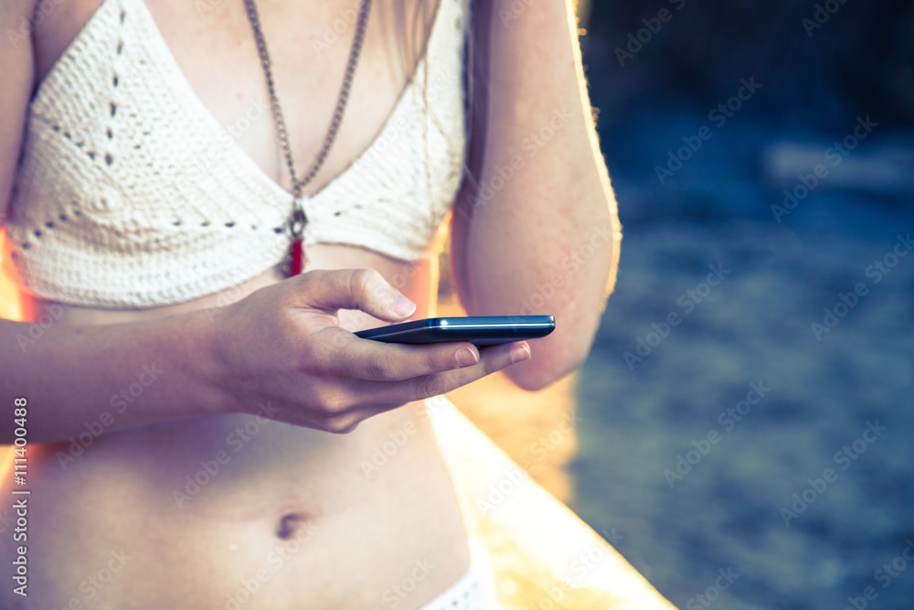 Girl with smart phone near beach Girl with smart phone near beach