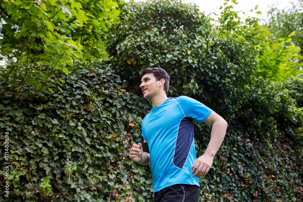 Healthy running runner man workout in a city park. Jogging male fitness model working out training on park road. Healthy running runner man workout in a city park. Jogging male fitness model working out training on park road.